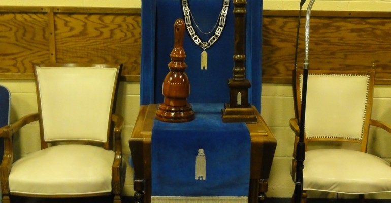 The Chair in the South, with jewel, apron, pillar, and gavel.